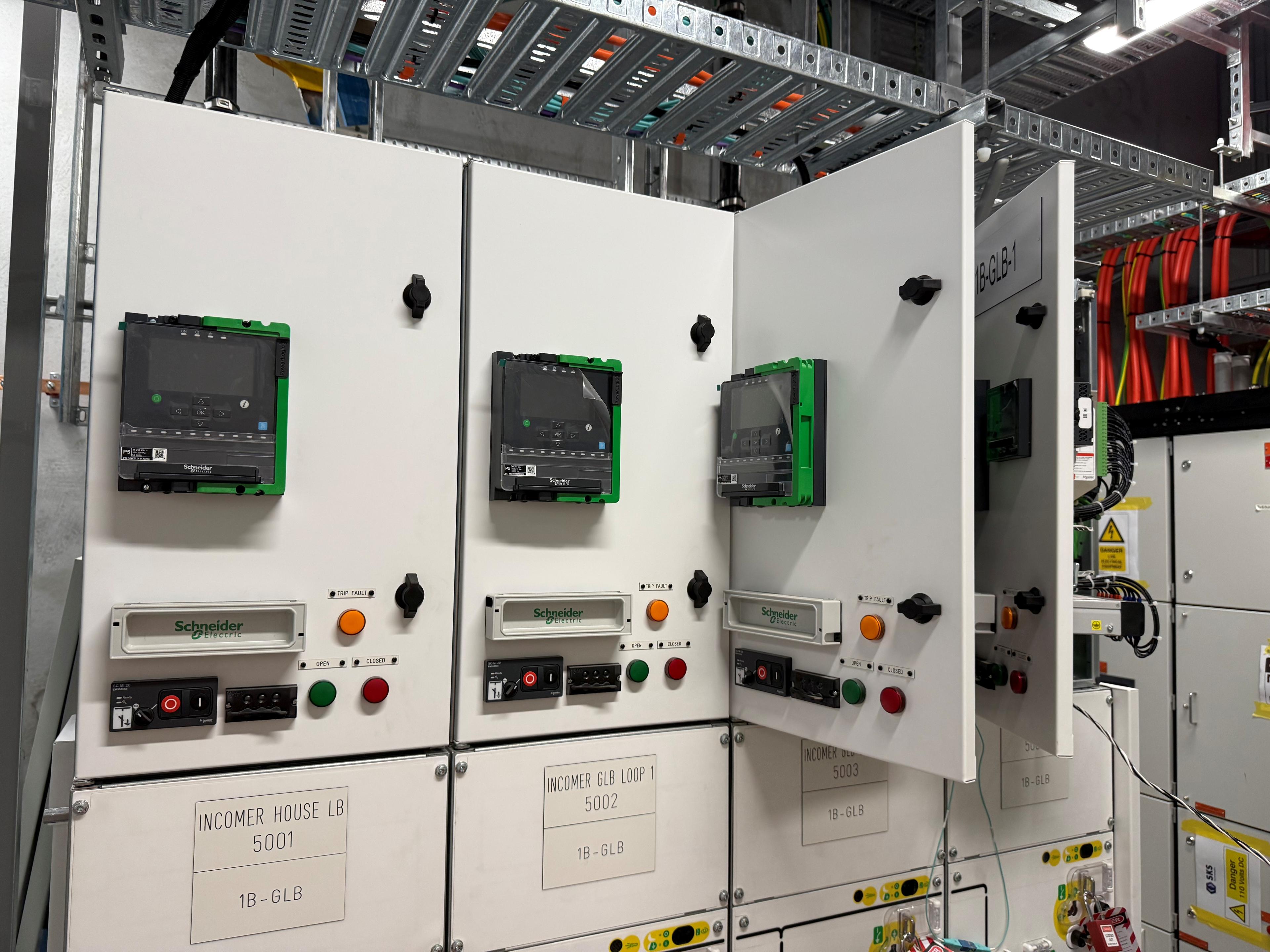 RMS-ES engineer testing protection relay panels in a substation switch room