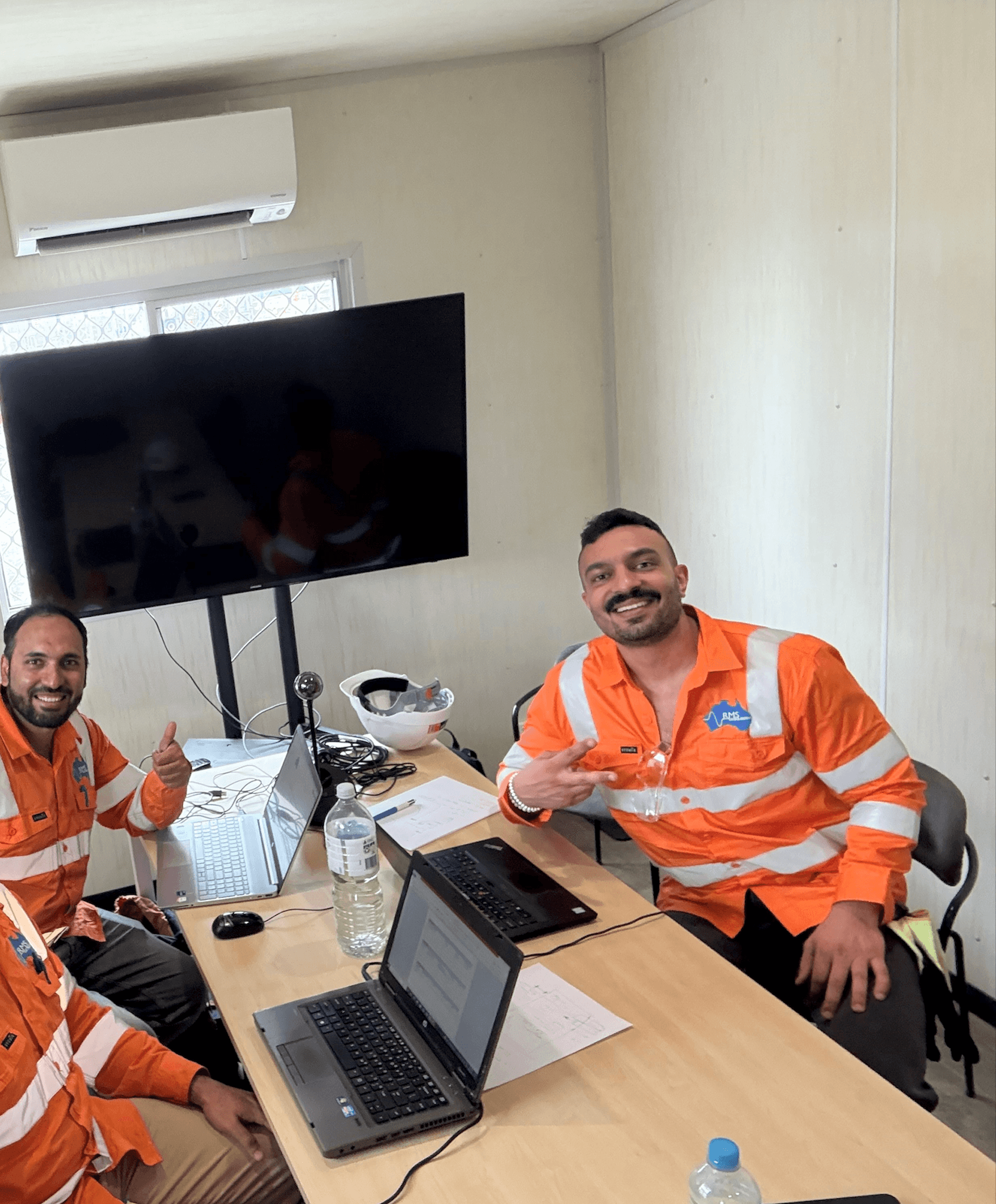 RMS field team reviewing site plans in a site office